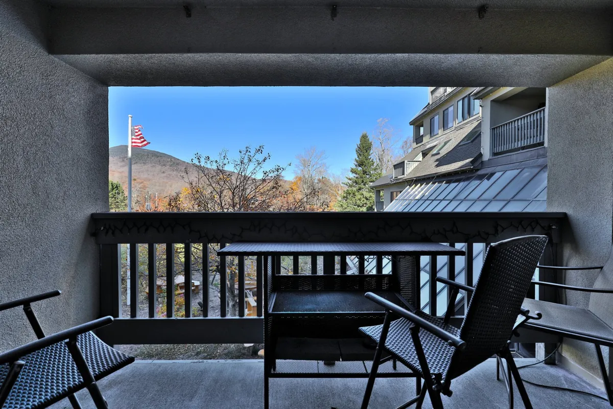A private patio scene with outdoor furniture and a railing, set against a backdrop of stunning mountain views. The image suggests a quiet spot for coffee, reading, or stargazing, aligning with the section's focus on privacy and scenic escapes.